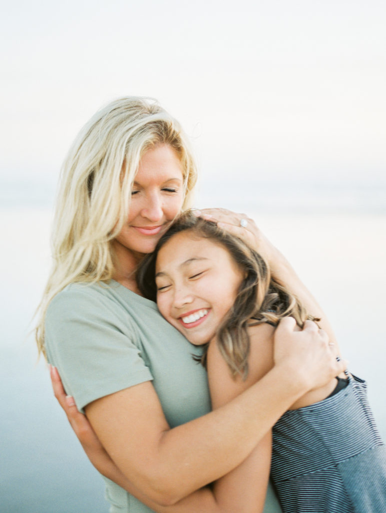 mom and daughter portrait on beach 